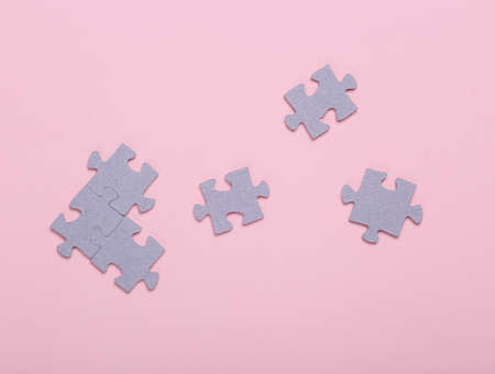 Puzzle pieces on a pink background. top view. Mental health, business, concept