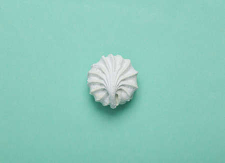 Sweet colored meringue on blue background. top view. flat layの写真素材