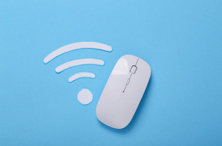 Paper cut Waves wi-fi icon and pc mouse on a blue background. top view