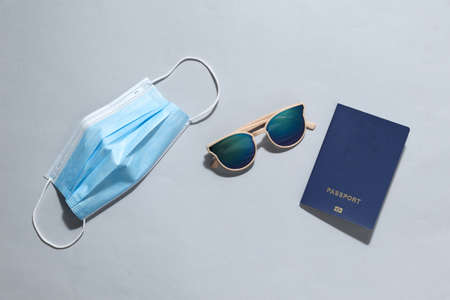 Concept of travel during the period of coronavirus or other pandemic and quarantine. Flat lay travel accessories on bright gray backgroundの写真素材
