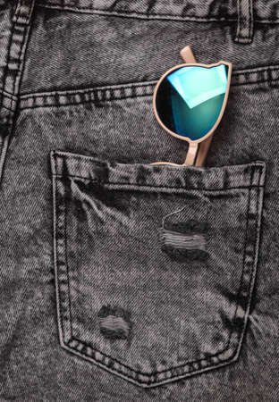 Stylish sunglasses in jeans pocketの写真素材