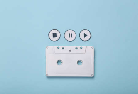 Audio cassette with icons start, stop, pause of media player on blue background. top viewの写真素材