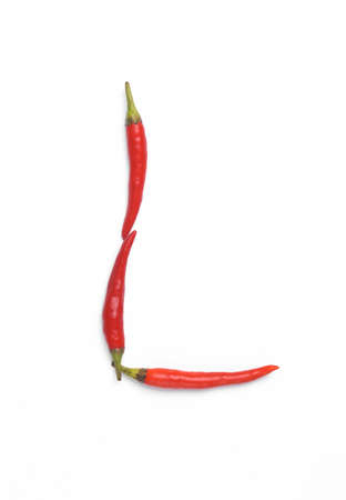 Letter L made from red chilli peppers isolated on white background