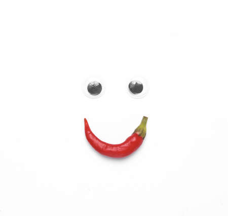 Face made of goggle eyes and chili peppers on white backgroundの写真素材