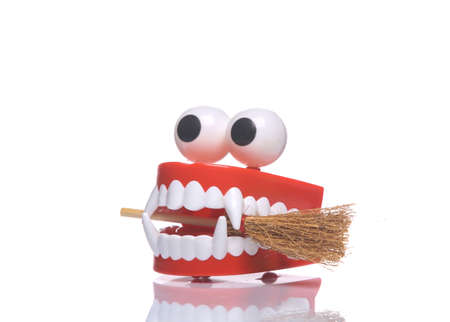 Clockwork jaws with fangs monster with broom isolated on white background with reflection. halloween...