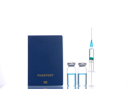 Syringe with vaccine bottle and passport isolated on white background with reflection. vaccinationの写真素材