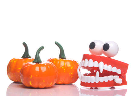 Clockwork jaws with monster fangs and pumpkin isolated on white background with reflection....