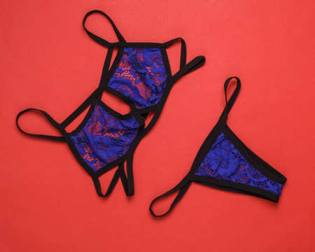 Sexy lace bra with panties on red background. Top view. Flat layの写真素材