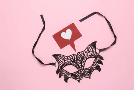 Lace cat mask with like icon on pink backgroundの写真素材