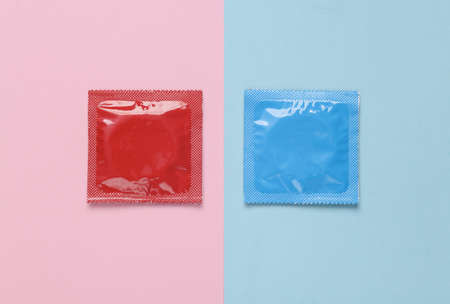 Two packs of condoms on a blue-pink pastel background. Top viewの写真素材