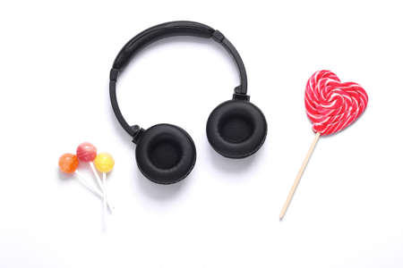Headphones with lollipops on a white background. Top view