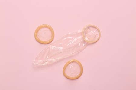 Condoms on a pink background. Contraceptives. Top viewの写真素材
