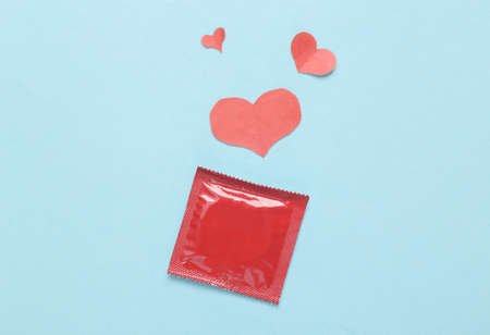 Pack of condoms with hearts on a blue backgroundの写真素材