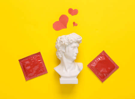 Bust David with hearts and condoms on yellow backgroundの写真素材