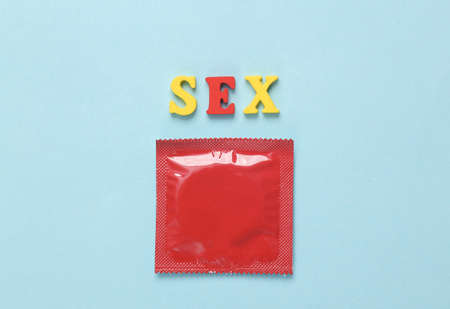 Red pack of condoms with the word sex on a blue backgroundの写真素材