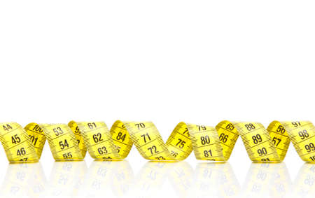 Yellow measuring tape isolated on white background with reflection. Diet, weight loss, concept