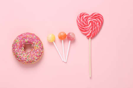 Donut with lollipops on a pink background.Top viewの写真素材