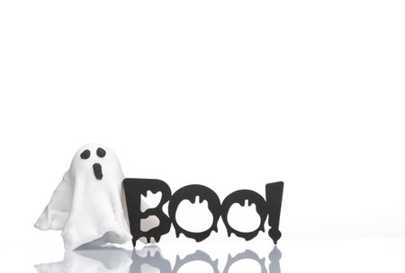 Little plasticine ghost and word boo! isolated on a white background