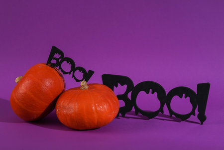 Halloween still life. Pumpkins with the words boo! on a purple backgroundの写真素材