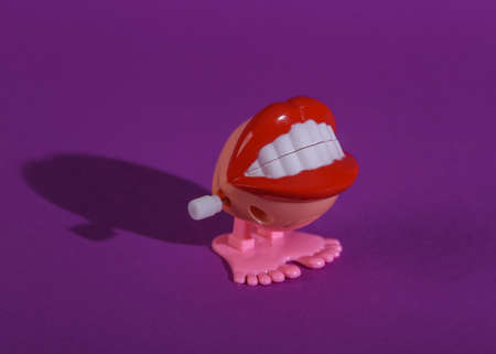 Clockwork halloween toy monster lips on purple backgroundの写真素材
