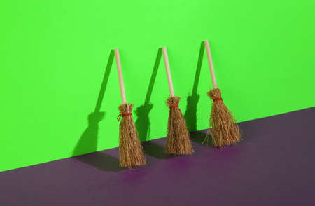 Witch brooms on a purple-green background. creative halloween layoutの写真素材