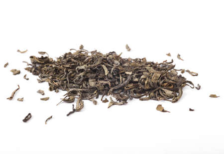 Dry green tea leaves isolated on white backgroundの写真素材