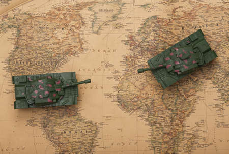 Toy tanks on a vintage word map.の写真素材
