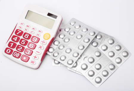 Calculator with blisters of pills on a white backgroundの写真素材