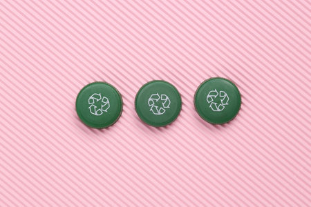 Plastic bottle cap with recycle symbol on pink background. Eco conceptの写真素材