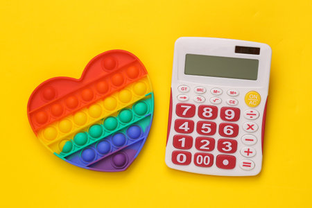 Antistress pop it sensory toy with calculator on yellow background
