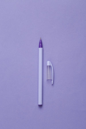 Purple pen with a cap on a purple background. minimal conceptの写真素材