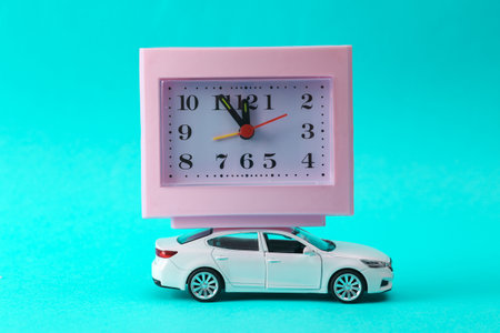 Car model with clock on a turquoise background