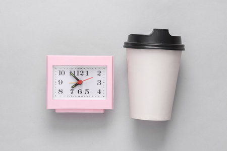 Coffee time, coffee break. Take away white cup and clock on gray background