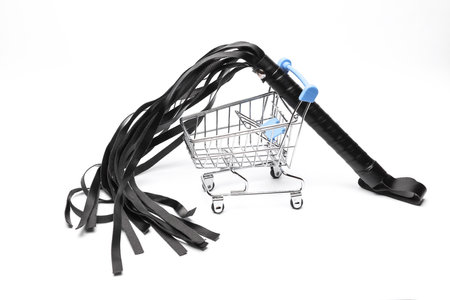 Shopping cart with bdsm leather whip on a white background. sex shop