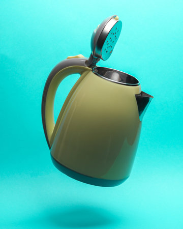 Electric kettle levitates on a blue backgroundの写真素材
