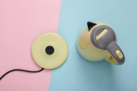 Plastic electric kettle on a blue-pink pastel background. top viewの写真素材