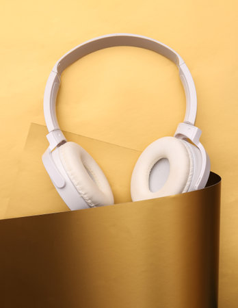 White headphones on a luxurious golden backgroundの写真素材