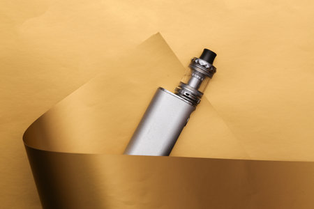 Vaping device on a luxurious golden backgroundの写真素材