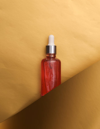 Facial serum bottle on a luxurious golden backgroundの写真素材