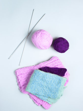 Knitting needles, thread balls, yarn on a gray background.の写真素材