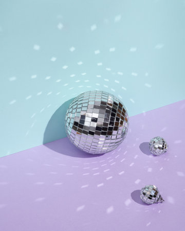 Creative minimal still life with mirrored disco balls on pastel background. party concept. visual trend. retro aestheticの写真素材