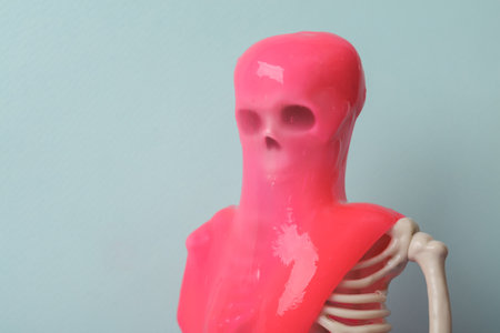 Minimalism halloween still life. Skeleton with slime on two tone pastel background. fresh ideas....