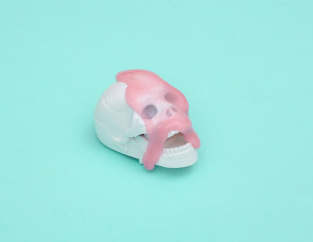 Creative Halloween layout, Skeleton skull swith slime on blue pastel background with shadow. visual...