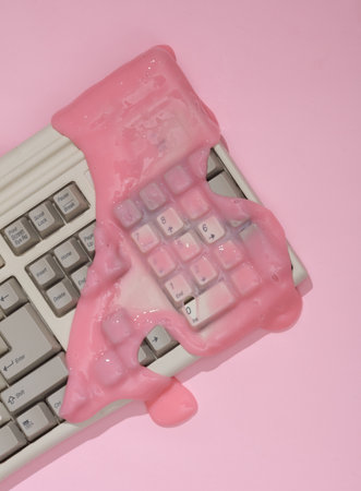 creative retro layout. Old keyboard with slime on pink background with shadow. visual trend. fresh...