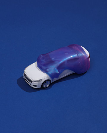 Creative layout, Toy car with slime on dark bue background with shadow. visual trend. fresh ideas....