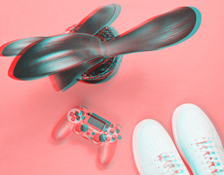 Glitch effect. Plastic gamepad, white hipster sneakers, home plant in pot on red background. space...