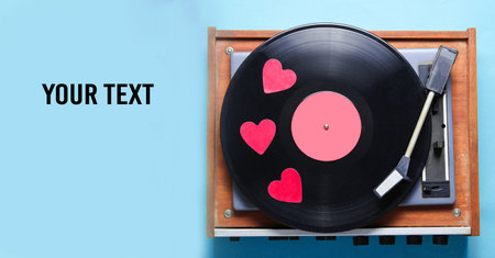 Retro culture, Valentine's Day. Decorative hearts on a vinyl record plate on blue background. Top view, minimalism. copy spaceの写真素材