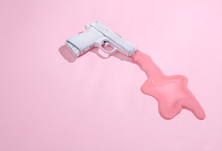 creative minimalist layout. Gun with slime on a pink background. Surreal summer ideas. Conceptual popの写真素材
