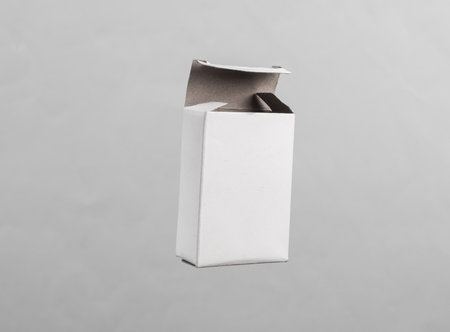 Butch white cardboard box levitating on gray background