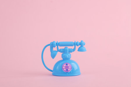 Model retro doll rotary phone on a pink background. pastel color trendsの写真素材